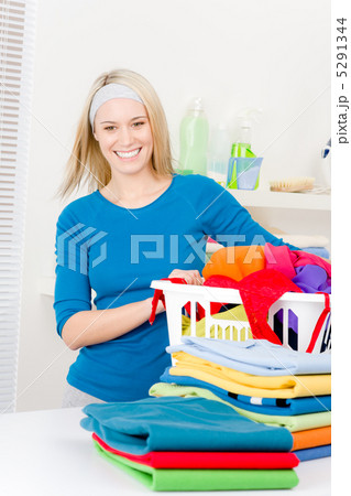 Laundry - woman folding clothes home Laundry - woman folding clothes home 5291344