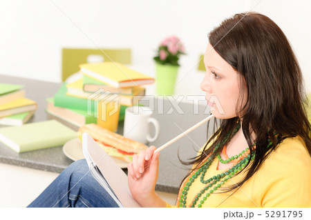 Young student girl thinking in kitchen 5291795