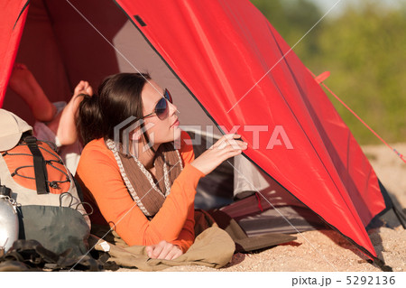 Camping happy woman in tent on beach 5292136
