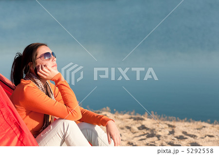 Camping beach woman by campfire in tent 5292558