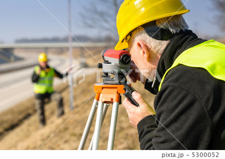 Geodesist measure land with tacheometer highway Geodesist measure land with tacheometer highway 5300052