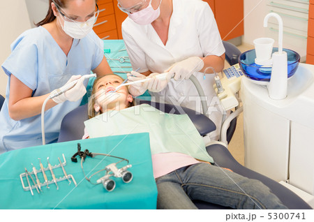 Dentist and assistant with child patient Dentist and assistant with child patient 5300741