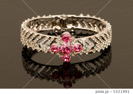 Bracelet with red stones on reflective background 5321991