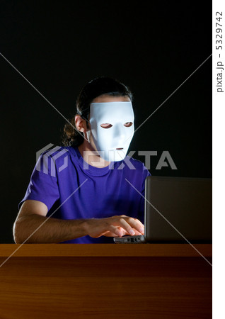 Hacker sitting in dark room 5329742