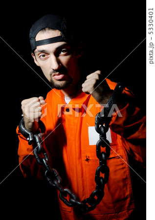 Inmate chained on black background 5330401
