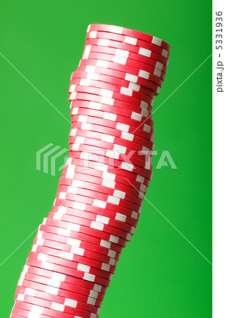 Stack of red casino chips against green background 5331936