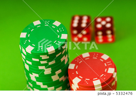 Casino chips and dice against green background 5332476