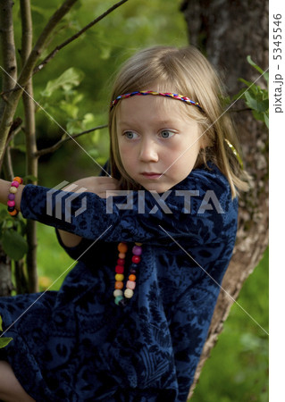 Little girl sitting on a branch of an apple tree 5345546