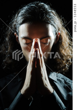 Young man praying in darkness 5348553