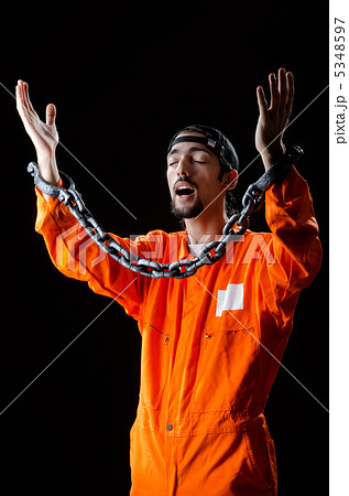 Inmate chained on black background 5348597