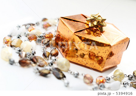 Golden gift box with decoration on white background Golden gift box with decoration on white background 5394916