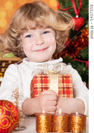 Happy child holding gift box Happy child holding gift box 5437359