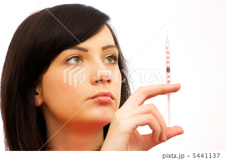 Woman checking syringe isolated on the white 5441137