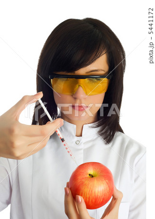 Woman scientiest injecting chemicals into apple on white 5441172