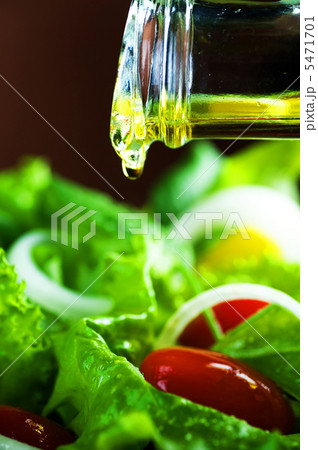 Healthy Salad And Pouring Olive Oil Closeup Healthy Salad And Pouring Olive Oil Closeup 5471701