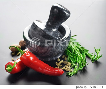 Mortar With Pestle And Herbs. Over Black Background 5483331