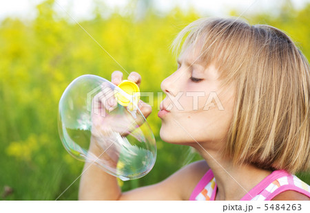 Little Girl Blowing Soap Bubbles 5484263