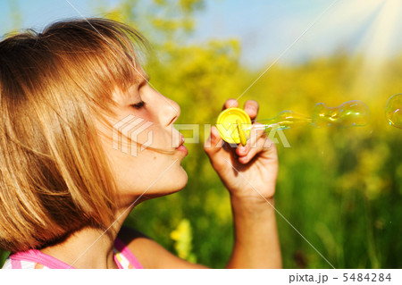 Little Girl Blowing Soap Bubbles 5484284