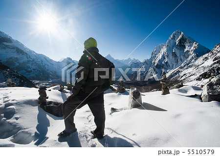 Climber and Cho La pass at daybreak in Himalayas 5510579
