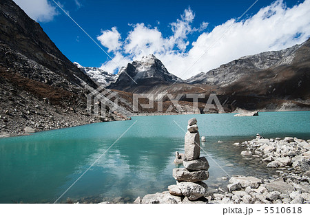 Harmony and balance: Pebble stack and Sacred Lake in Himalayas 5510618