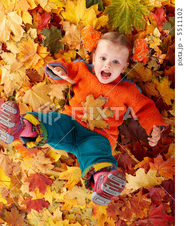 Girl child in autumn orange leaves. Girl child in autumn orange leaves. 5511102