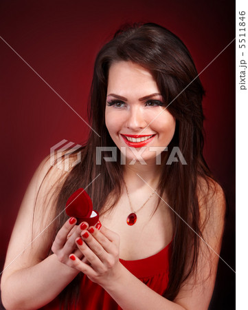 Girl with jewellery box on red background. 5511846