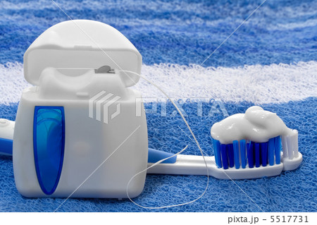 dental floss and toothbrush on a towel dental floss and toothbrush on a towel 5517731