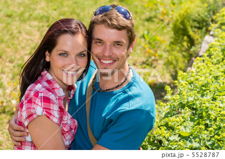 Young happy couple embracing in sunny park Young happy couple embracing in sunny park 5528787