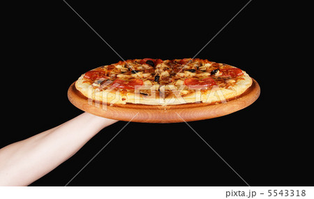 Tasty pizza in wooden plate 5543318