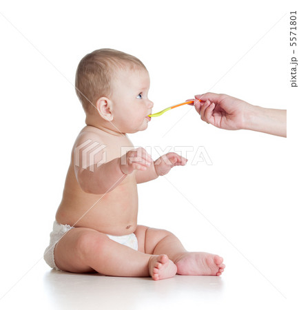 Little baby feeding with a spoon Little baby feeding with a spoon 5571801