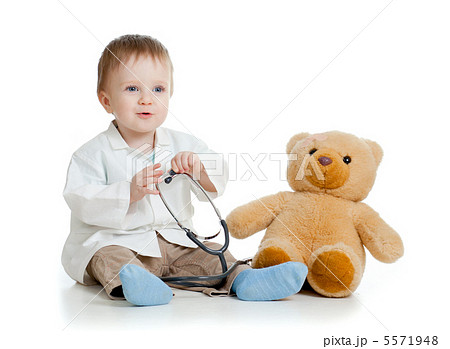 Adorable boy with clothes of doctor and teddy bear over white 5571948