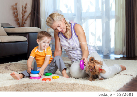 mother, child boy and pet dog playing together indoor mother, child boy and pet dog playing together indoor 5572681