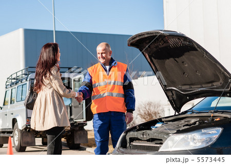 Woman shaking hands with mechanic car breakdown Woman shaking hands with mechanic car breakdown 5573445