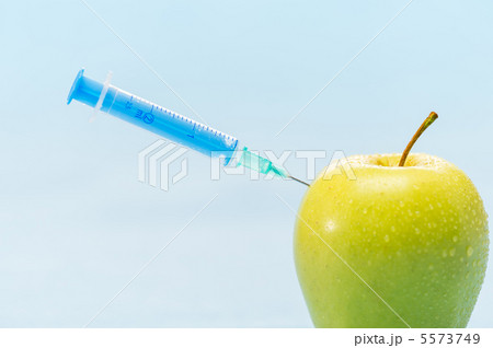 Green apple and syringe genetically modified foods Green apple and syringe genetically modified foods 5573749