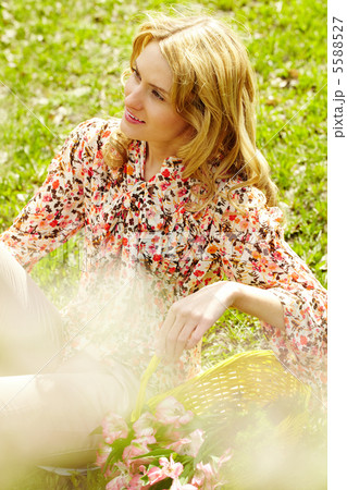 Woman sitting on grass Woman sitting on grass 5588527