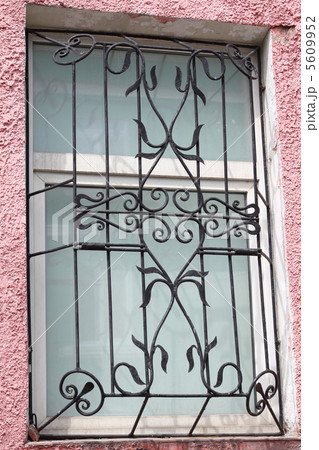 black metal forged carved lattice at a plastic white window 5609952