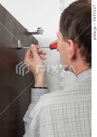 Worker twists the screw 5645337