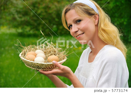 Happy young woman holding fresh eggs Happy young woman holding fresh eggs 5773174