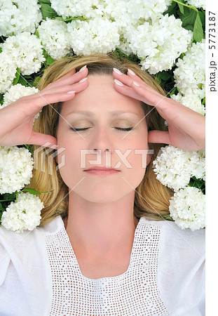 Young woman laying in flowers - snowballs Young woman laying in flowers - snowballs 5773187