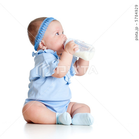 adorable baby girl drinking milk from bottle without help 5784929
