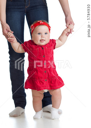 little baby girl doing first step with help of mother 5784930
