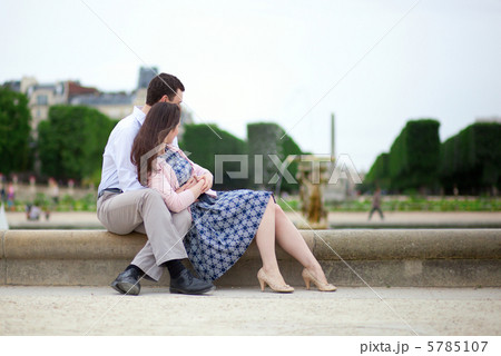 Romantic couple sitting by the water in Luxembourg garden of Par 5785107