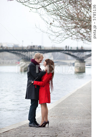 Romantic couple in love hugging near Pont des Arts in Paris at s 5785136
