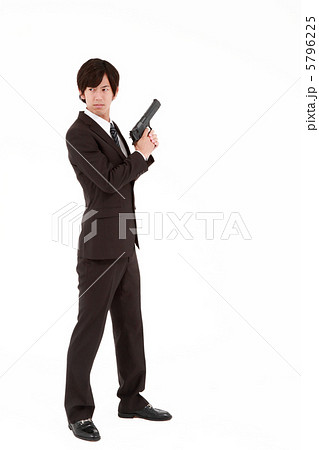 銃を構えるビジネスマンの写真素材