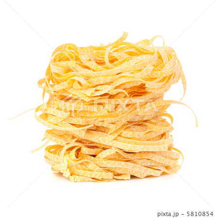 Italian pasta tagliatelle nest isolated on white background Italian pasta tagliatelle nest isolated on white background 5810854