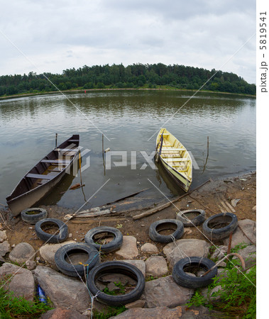 Rowing boats moored on a river bank 5819541