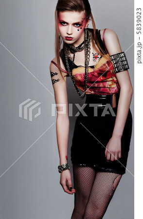 Pretty girl punk with creative make-up and clothes posing 5839023