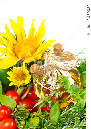 herbs with tomatoes, sunflowers and bottle of plant oil herbs with tomatoes, sunflowers and bottle of plant oil 5880082