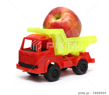 food transportation concept - toy lorry with apple 5888904
