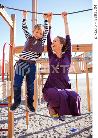 Mother and son playing at playground. Mother and son playing at playground. 5893504